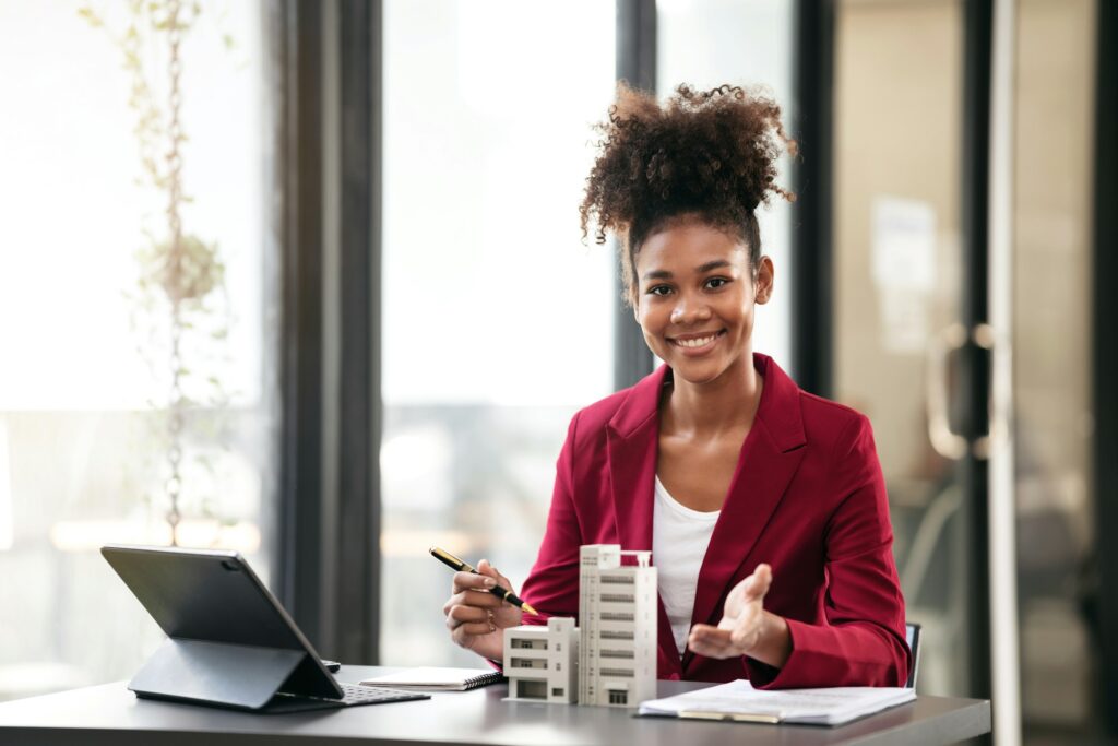 African american businesswoman in suit pointing condominium mode