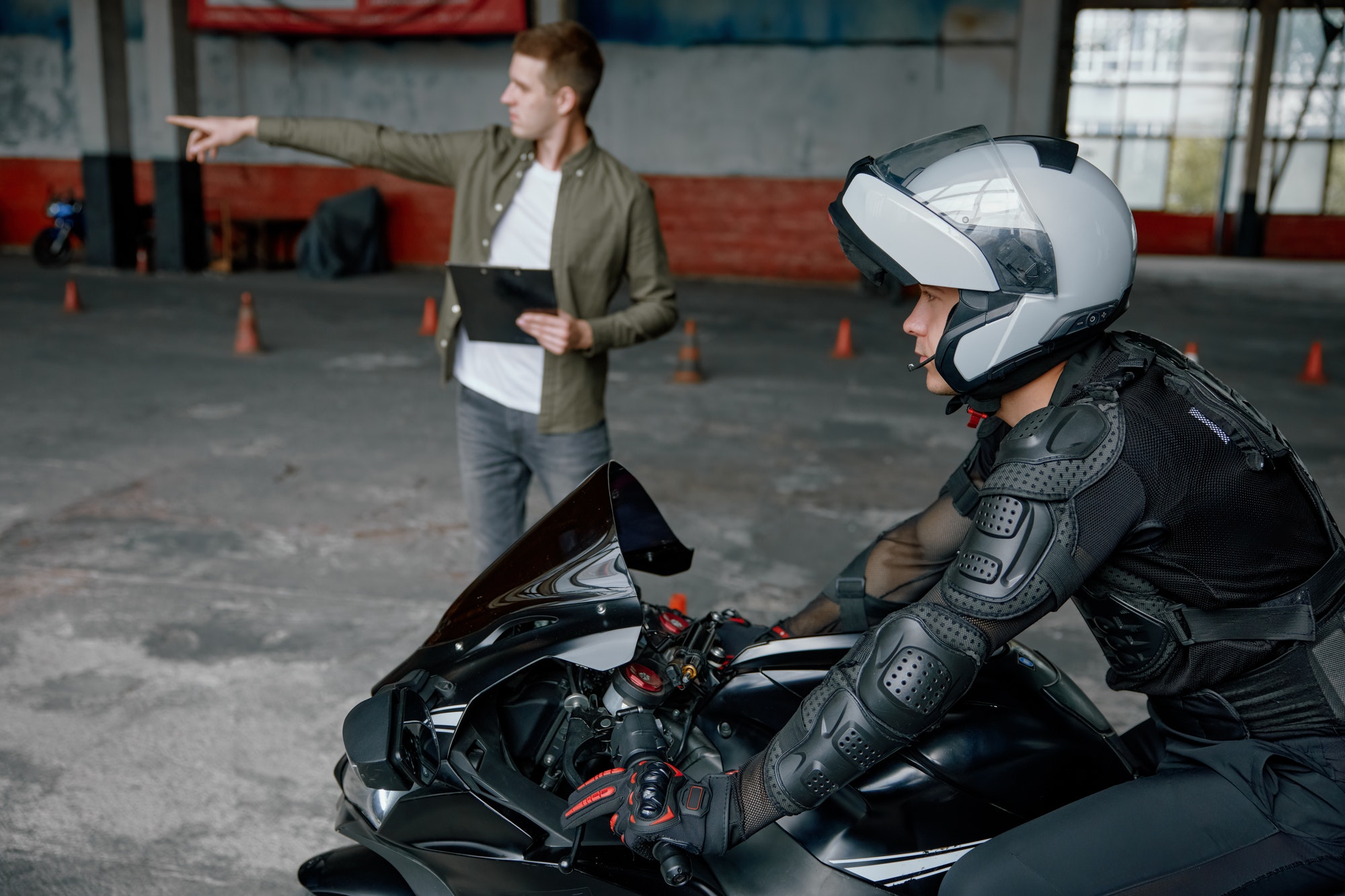 Driving practice at motorcycle driver training center with indoor motordrome